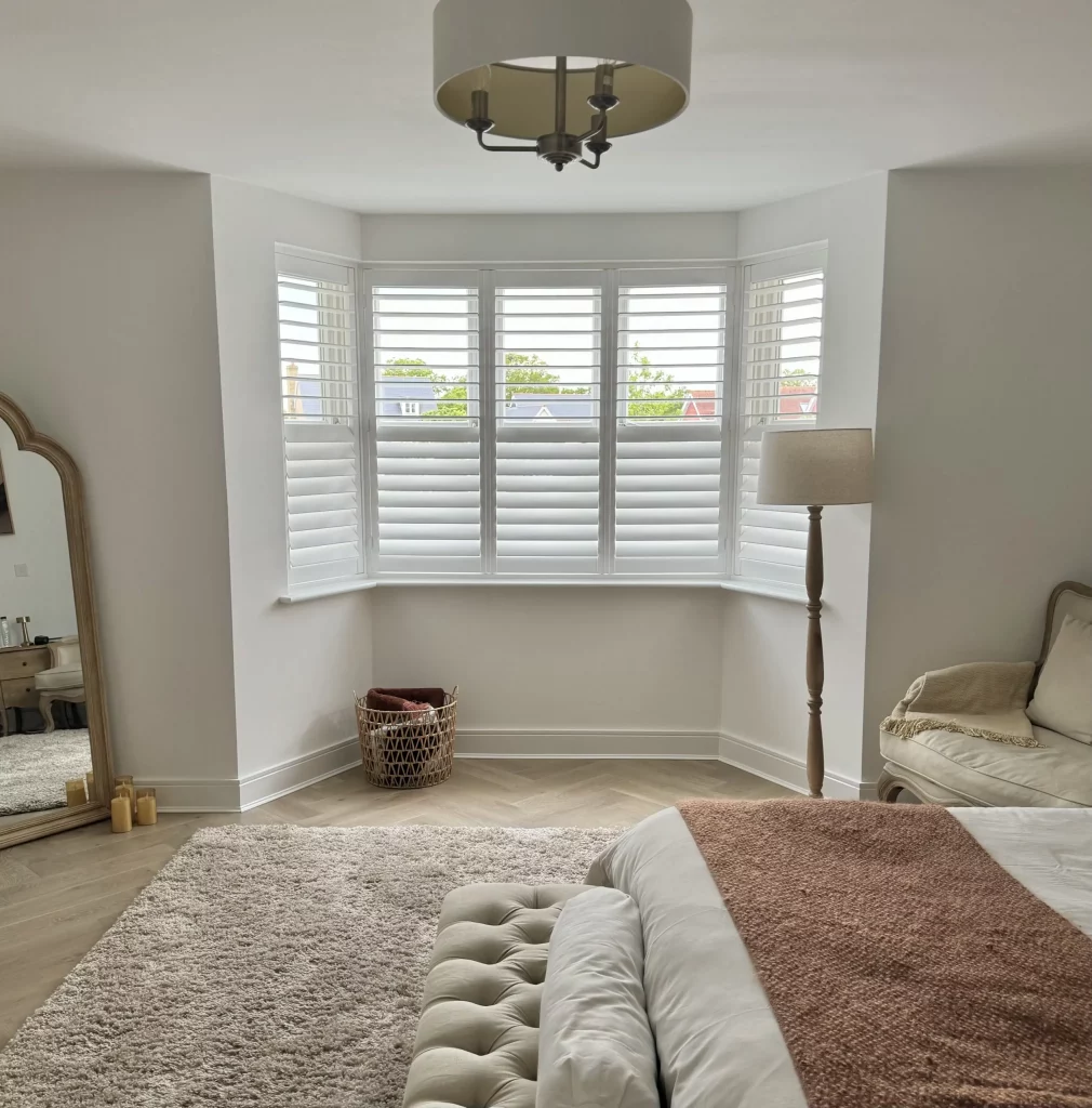 Bay window shutters in a bedroom